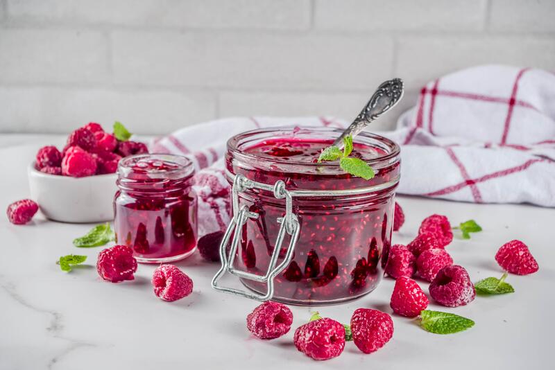 Glas selbstgemachte Marmelade mit frischen Himbeeren