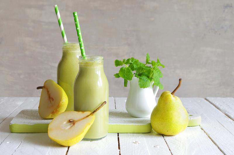 Zwei Glasflaschen mit Birnen-Smoothie