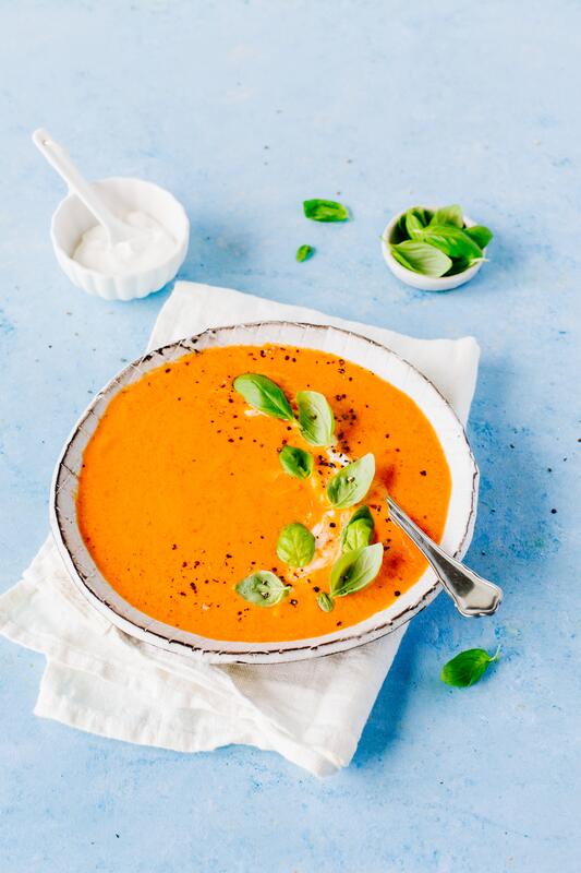 Suppe in Schüssel auf blauem Grund