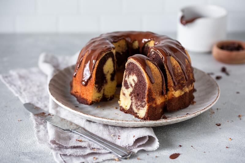 Teller mit angeschnittenem Gugelhupfkuchen mit Marmorierung