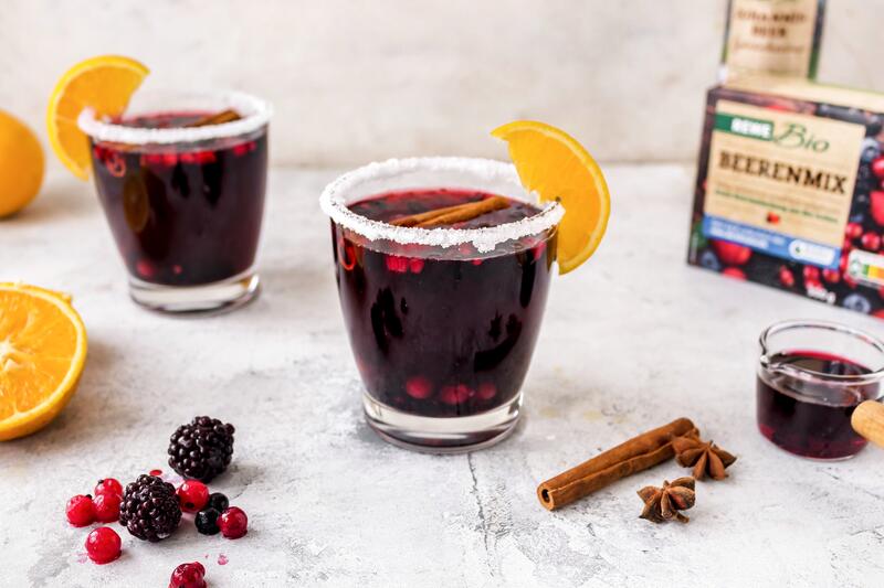 Zwei Gläser mit einem roten Getränk, garniert mit Orangenscheiben