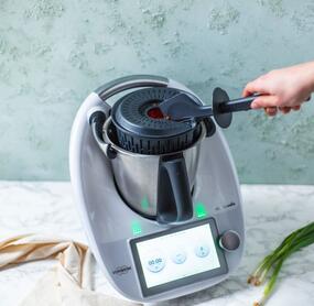 Garkorb wird mithilfe des Spatels aus dem Mixtopf genommen